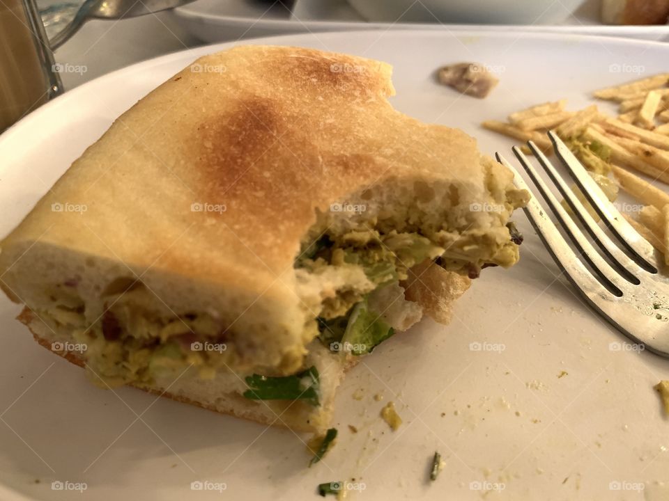 The bite of chicken curry sandwich. 