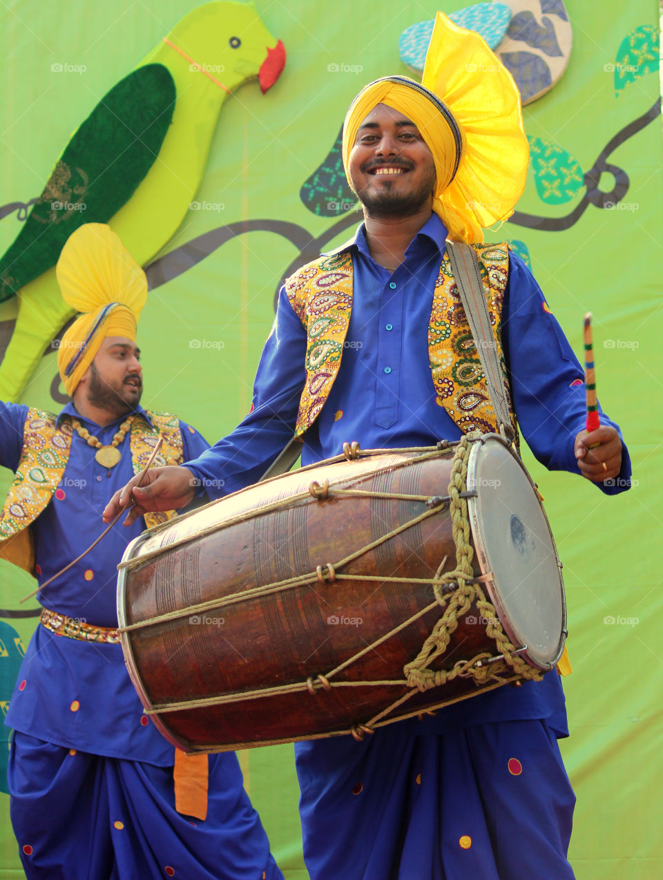Close-up of a happy man playing drum
