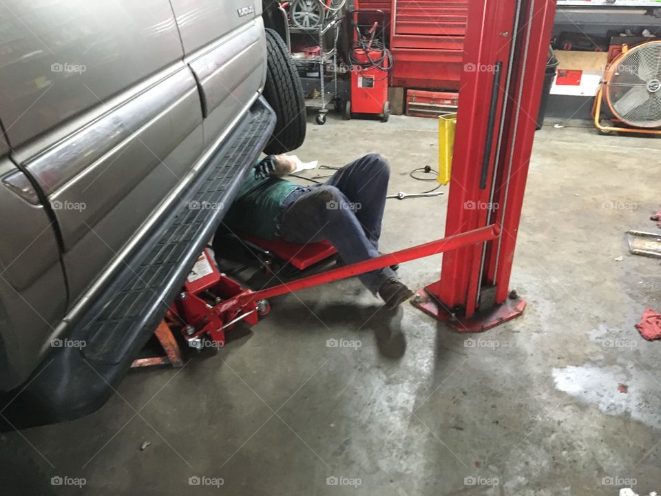Mechanic working on suv