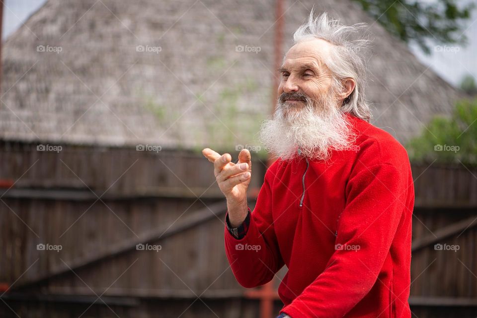 A bearded old man riding a bicycle