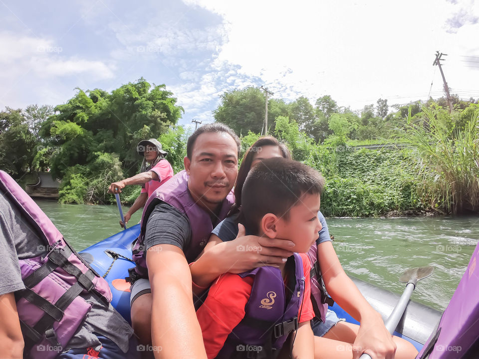 Tourists on the inflatable boat floating on the water in the river The flow of Kaeng Krachan Dam at Phetchaburi in Thailand. June 10, 2019