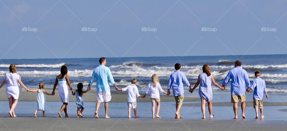 Family on the beach walking toward the ocean