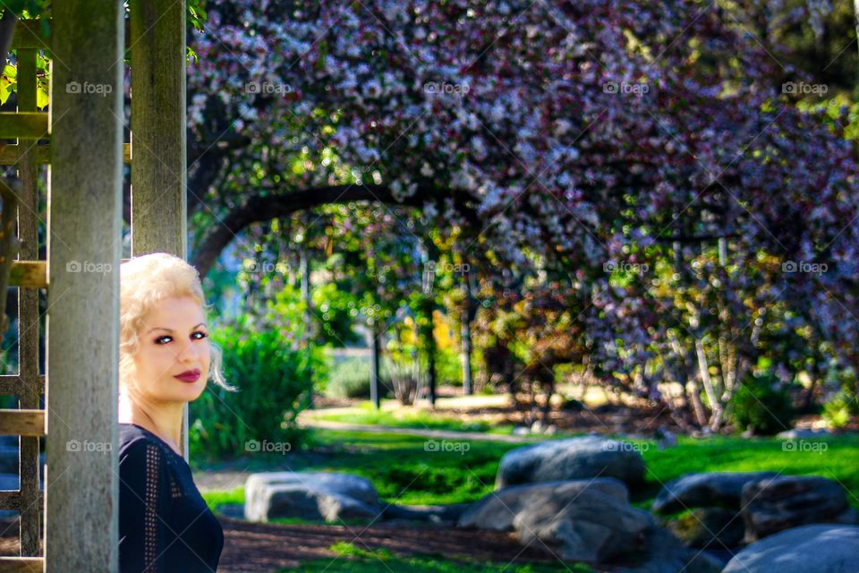 Attractive woman standing in beautiful park