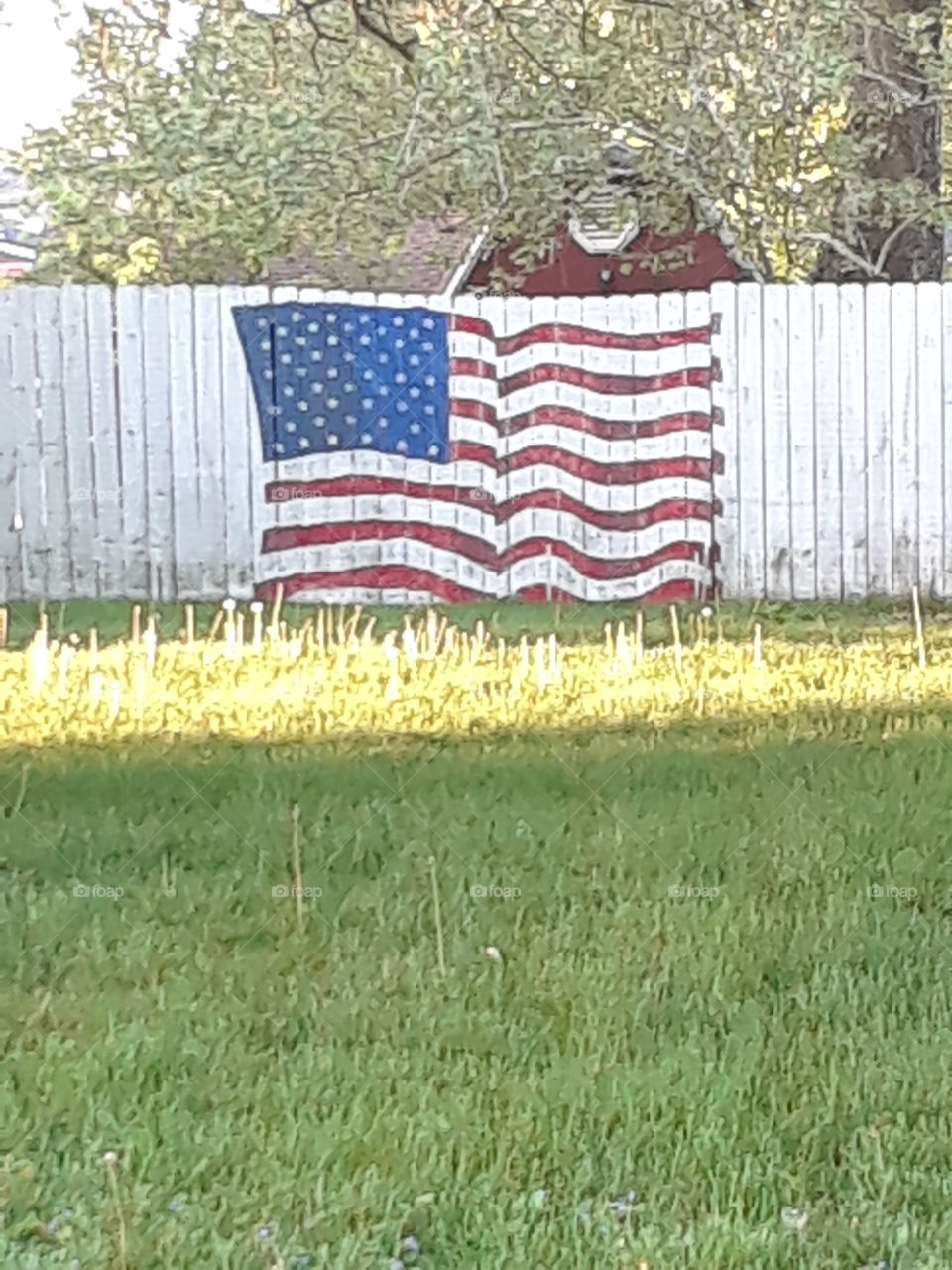 American Flag painted on a white fence