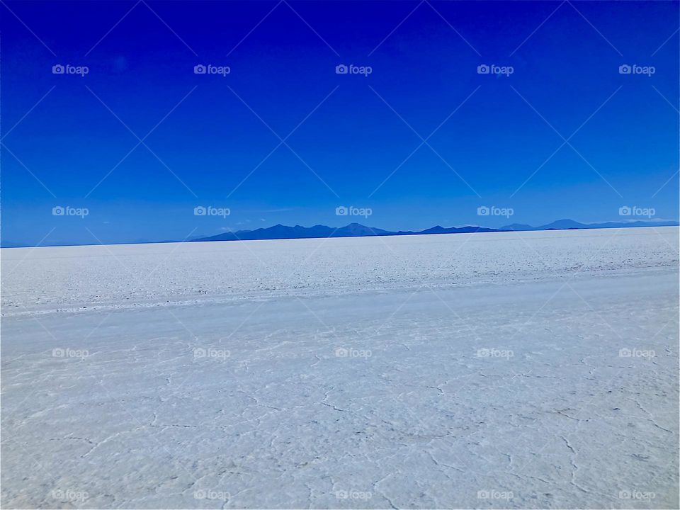 This white landscape is the dry area of the “Uniyuni Salt Lake” in “Bolivia” in “Central America”. It is entirely made up of white salt deposits at the shores of this gigantic lake. 2022. Hypnotic Productions