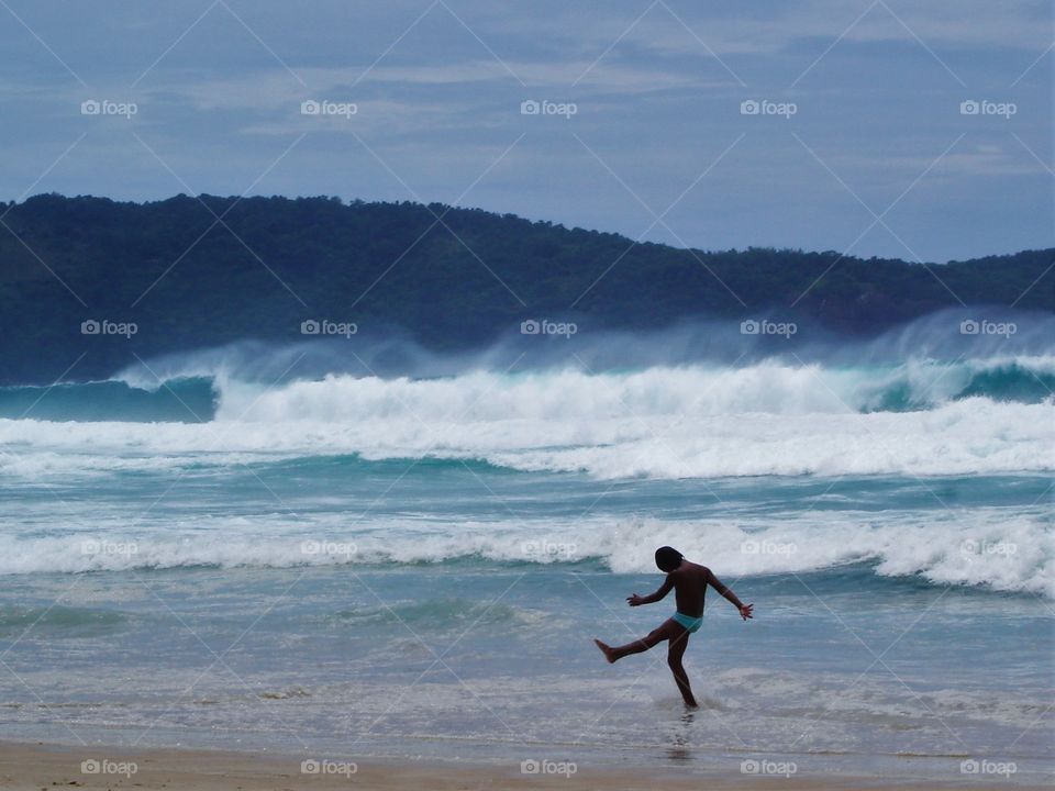 Child walking at the beach