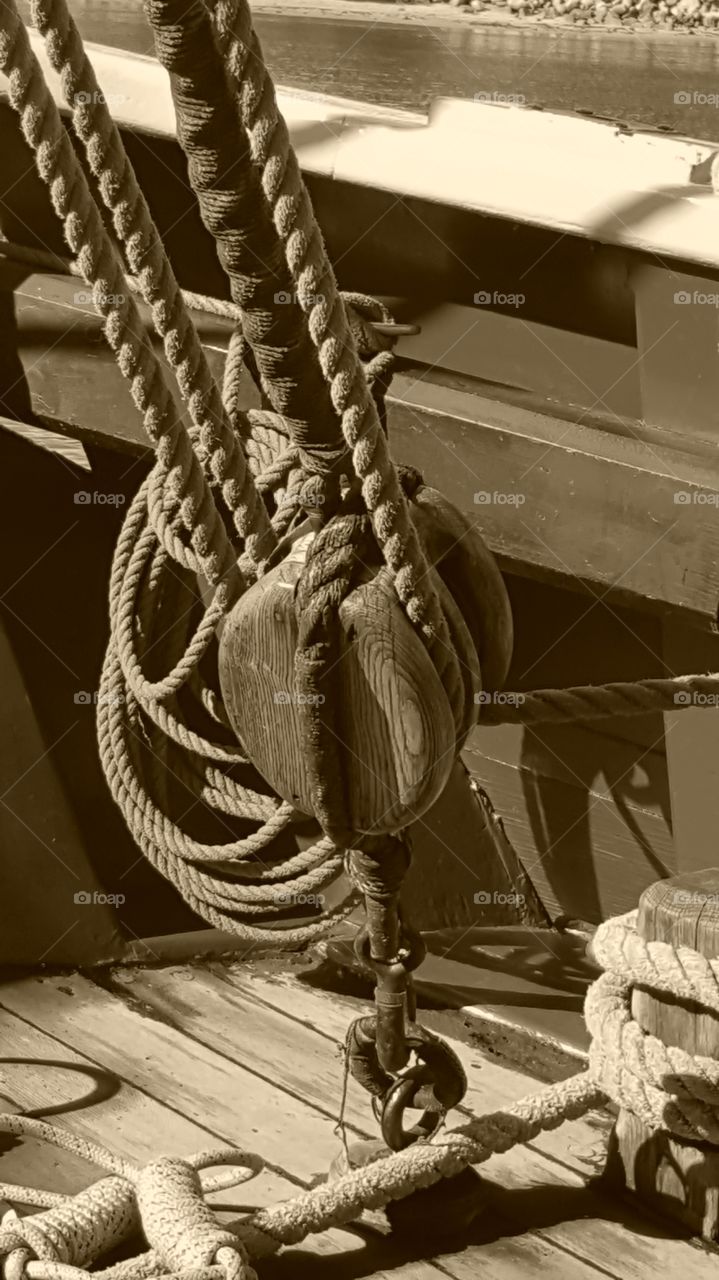 huhe eooden blocks to hold rigging on the deck of a rall sailing ship in Monterey, Ca