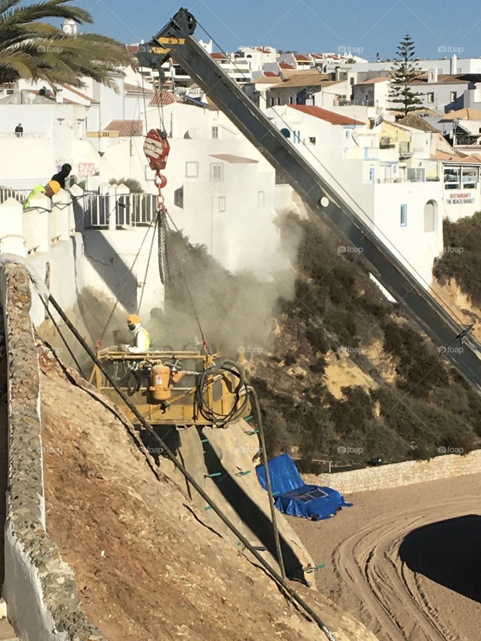 At work : fixing a dangerous cliff in the city